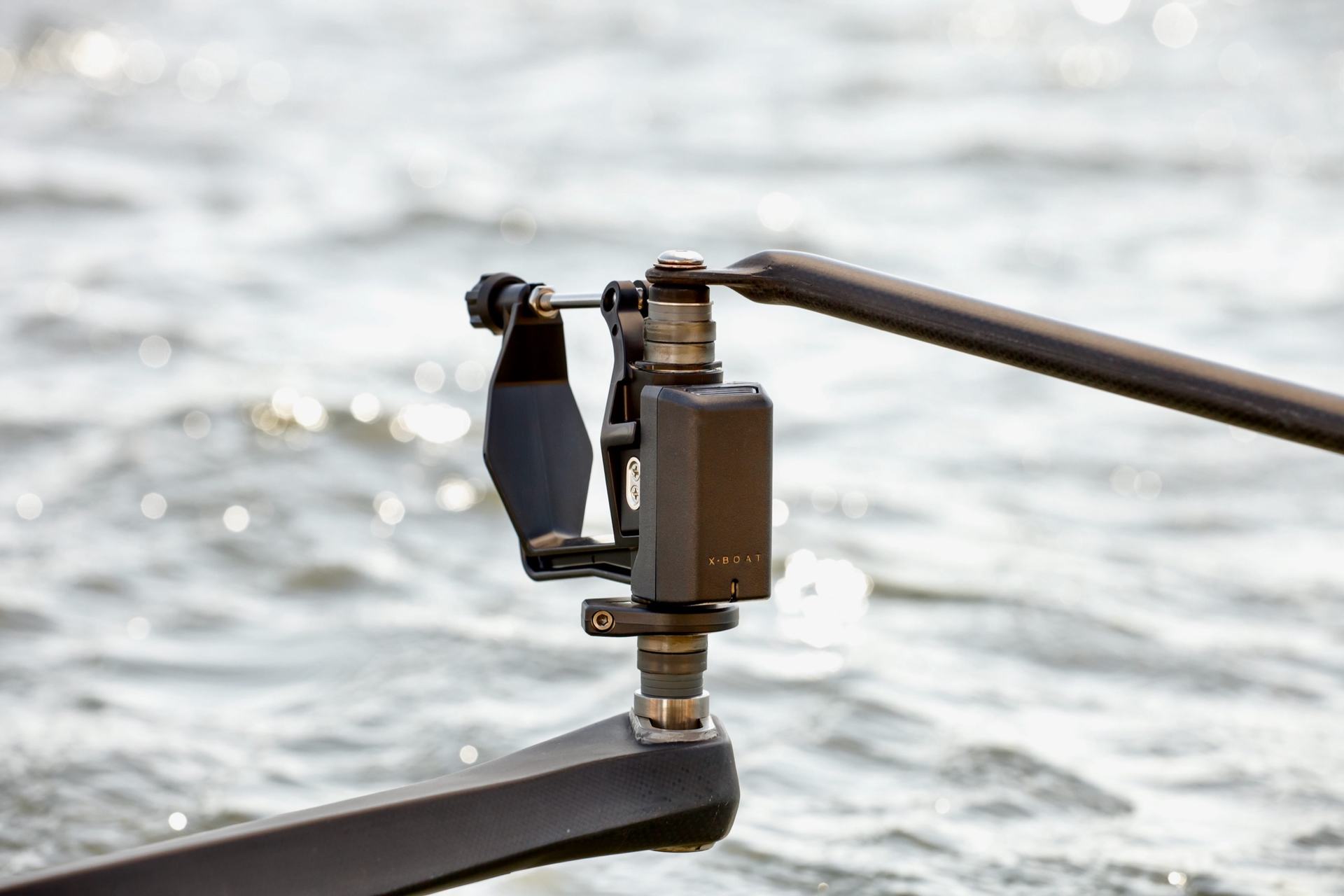 The XBoat Oarlock fitted to a rigger, close up, with water behind
